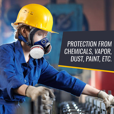 Person wearing a yellow hard hat, blue protective suit, and respirator mask in an industrial setting.